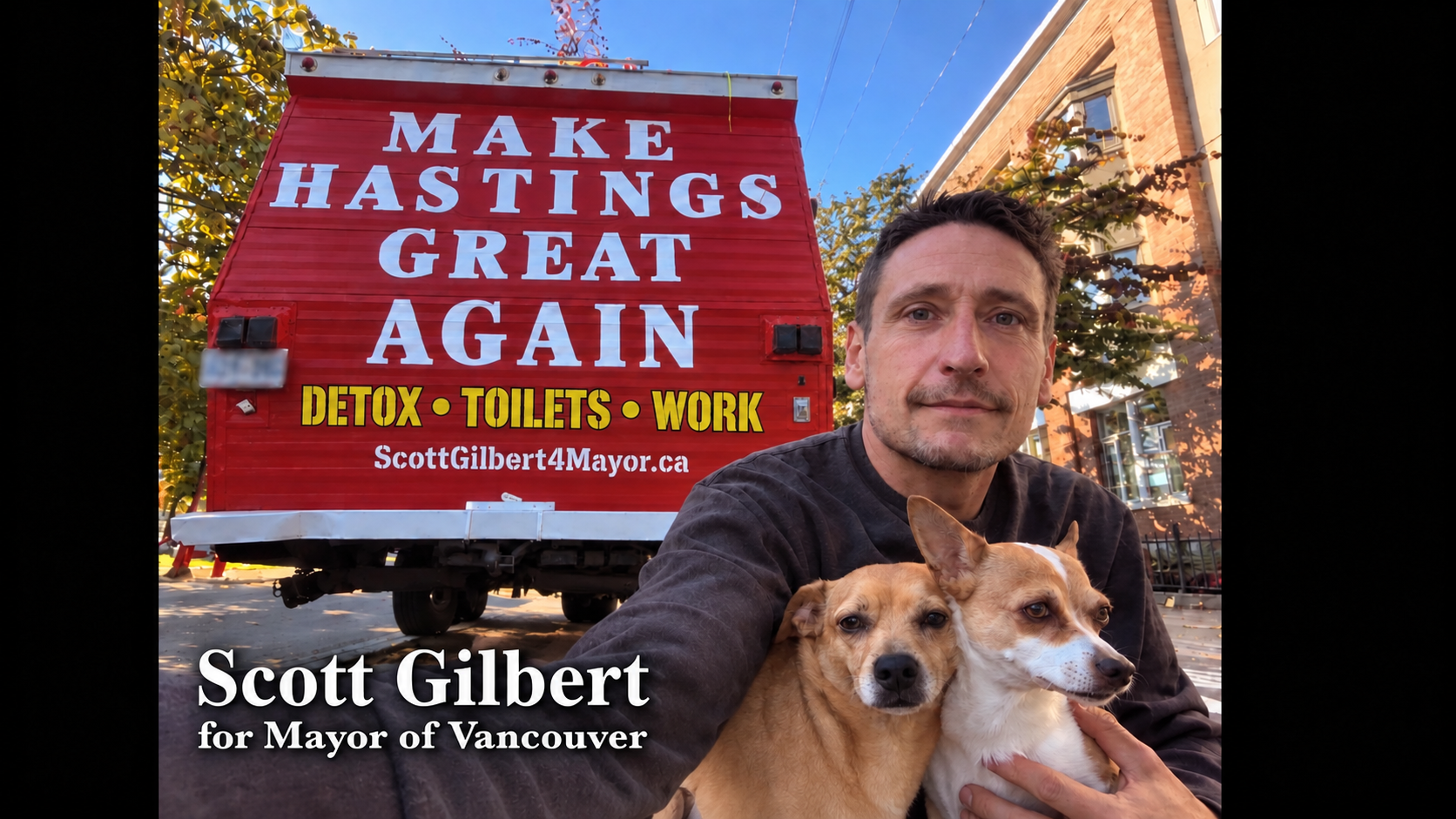Scott Gilbert with two dogs in front of his Make Hastings Great Again campaign bus